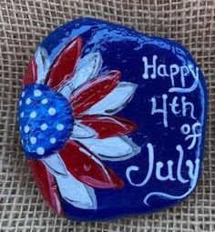 a painted rock with the words happy 4th of july on it