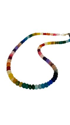 This necklace is a vibrant and eye-catching piece of jewelry that features colorful rondelle beads in a rainbow spectrum of shades. The necklace measures approximately 20 to 21 inches in length and can be adjusted to a shorter length, allowing for a customized fit. The rondelle beads are small, cylindrical-shaped beads that have been faceted to catch and reflect light, enhancing their brilliance and adding a touch of sparkle to the necklace. The beads are arranged in a rainbow pattern, with each color seamlessly transitioning into the next, creating a visually captivating and joyful design. The rainbow shades of the rondelle beads may include vibrant hues such as red, orange, yellow, green, blue, indigo, and violet. This colorful arrangement adds a playful and lively element to the necklac Adjustable Rainbow Polished Beads Necklace, Adjustable Rainbow Necklaces With Polished Beads, Rainbow Rondelle Gemstone Bead Necklaces, Rainbow Rondelle Gemstone Beads Necklace, Rainbow Single Strand Beaded Necklaces With Round Beads, Adjustable Rainbow Single Strand Beads, Adjustable Single Strand Rainbow Beads, Rainbow Rondelle Gemstone Beaded Necklace, Multicolor Single Strand Rondelle Beaded Necklaces