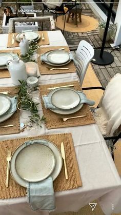 the table is set with plates and silverware