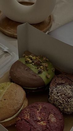 a box filled with assorted pastries on top of a table