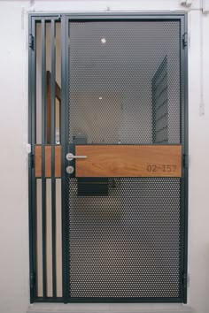 an open door with a wooden handle on the side and metal bars at the top