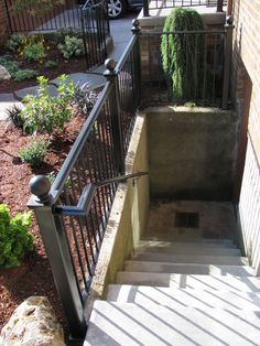 the stairs lead up to an apartment building with iron railings and handrails