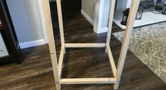 a wooden shelf sitting on top of a hard wood floor