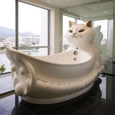 a white cat statue sitting inside of a bathtub in a bathroom next to a window