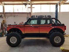 a red and black truck parked in a garage