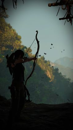 a woman with a bow and arrow in the woods looking up at birds flying overhead