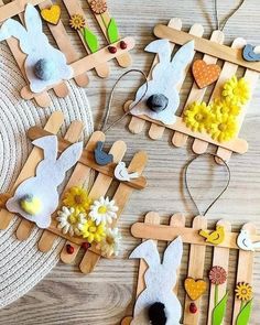 wooden pegs are decorated with easter bunnies and flowers