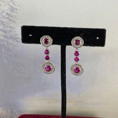 4ct Total Weight Red Ruby & White Cz's 925 Solid Sterling Silver Post Earrings Faceted Round Ruby And Sprinkling White Cz's 925 Silver Earrings Settings 1.25 Inch Drop Top Ruby Is 4mm And Bottom Ruby Is 5 Mm July Birth Stone Is Ruby And This Is One Great Birthday Gift Earth Mined Rubies That Are Heat Enhanced To Bring Out The Deep Red Color Post, Stud, Earth Mined, Red Rubies Formal Red Diamond Earrings With Brilliant Cut, Ruby Earrings With Brilliant Cut In Fine Jewelry Style, Ruby Brilliant Cut Fine Jewelry Earrings, Fine Jewelry Ruby Earrings With Brilliant Cut, Ruby Earrings Brilliant Cut Fine Jewelry, Ruby Earrings With Brilliant Cut For Anniversary, Anniversary Ruby Earrings With Brilliant Cut, Classic Red Diamond Earrings With Accents, Red Brilliant Cut Fine Jewelry Earrings