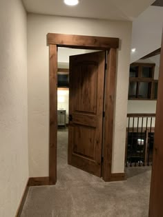 an empty room with a wooden door in it