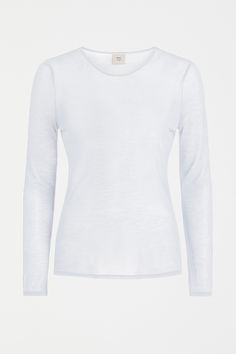 Product Details The Sheer Long Sleeve Tshirt is crafted from a silky and breathable TENCEL™ blend. Like a second skin, this contoured fit long sleeve is intended to fit neatly against the body. Ideal for layering, the Sheer Long Sleeve Tshirt is designed with a longer length making it perfect for tucking in and staying put. Layer underneath shirting for extra warmth or play with the shirt's sheerness and layer under the Kupa Knit Vest to expose the sleeves. Contains TENCEL™, an ELK environmental White Undershirt Long Sleeve, White Fitted Long Sleeve Mesh Top, White Unisex Long Sleeve Top, White Long Sleeve Moisture-wicking Top, White Moisture-wicking Long Sleeve T-shirt, Fall Winter Fashion Trends, White Long Sleeve Top, Jersey Top, Knit Vest