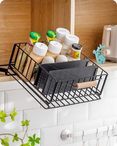 a wire basket filled with condiments on top of a counter