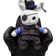 a stuffed animal sitting on top of a black chair