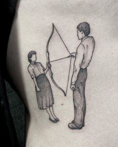 a woman holding a bow and arrow next to a man