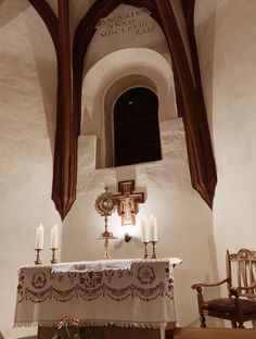 the altar is decorated with candles and an ornate cross on it's side wall