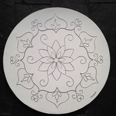 a white plate with an intricate design on it