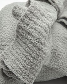 a pile of gray towels folded on top of each other