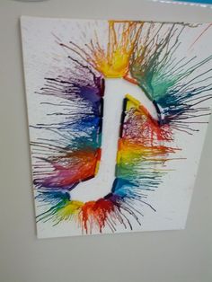 the letter j is made up of colored paint splattered on it's surface