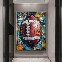 a football painting hanging on the wall in a room