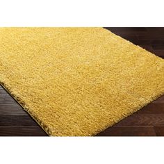 a yellow area rug is on the floor