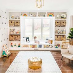 a living room filled with furniture and lots of shelves full of books on top of them