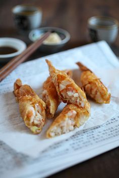 some food is sitting on a napkin with chopsticks