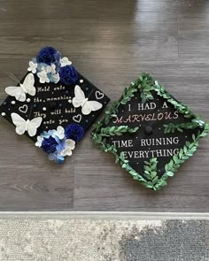 two graduation caps decorated with flowers and leaves on the floor in front of a sign that says i had marvelous time running everything