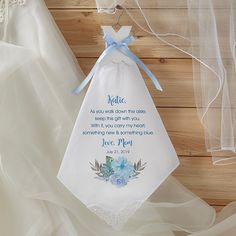 a white bag with blue flowers on it and a ribbon tied around the bottom that says, jesus you walk down the aisle