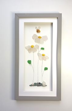 a white frame with some flowers in it