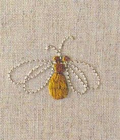 the embroidered bee is yellow and has beading on it's back end,