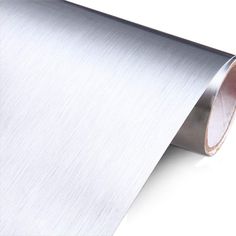 a roll of silver colored paper on a white background