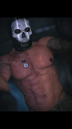 a shirtless man with a skull on his chest and no shirt wearing a mask