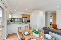 a living room and dining area with sliding glass doors