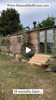 a small wooden house sitting on top of a lush green field