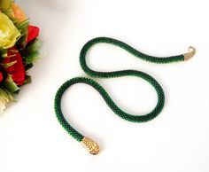 "Handmade crocheted beaded snake necklace made from Czech beads. Necklace of green and yellow-green golden snake beads. Jewelry Green Snake. Lightning in the form of the head and tail of a snake. Crocheted necklace. It will be a great gift. Necklace will emphasize your individuality, originality and uniqueness. Necklace length 50 cm (20 \"), thickness 0.7 cm. If you have any questions, please contact me. Please contact me for a different size or color. I will complete your order within 7 days. T Handmade Green Beaded Lariat Necklaces, Handmade Green Lariat Beaded Necklace, Green Snake Necklace, Beaded Snake, Snake Choker, Golden Snake, Unusual Necklace, Native American Necklace, Beadwork Necklace