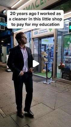 a man standing on the sidewalk in front of a store talking to someone else about it