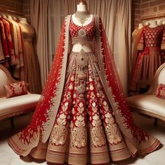 a red and gold bridal gown on display in a room with mannequins