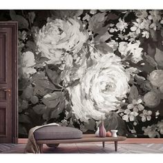 a living room with flowers on the wall