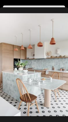 the kitchen is clean and ready to be used for dinner or breakfast time, with modern lighting