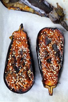 two eggplant halves with sesame seeds on them