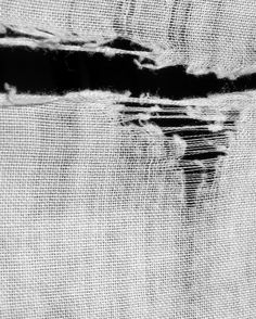 black and white photograph of fabric with water reflection on it's back side, taken from above