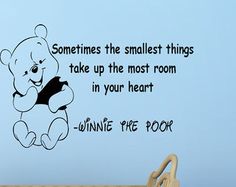 winnie the pooh quote wall decal on a baby's crib next to a teddy bear