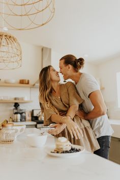 two women are standing in the kitchen and one is holding her face to each other