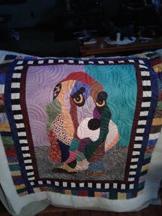 a dog is depicted on a colorful quilt