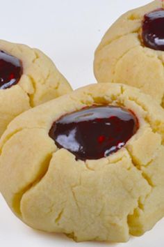 three cookies with jam on them sitting next to each other