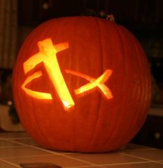 a carved pumpkin with the letter t on it