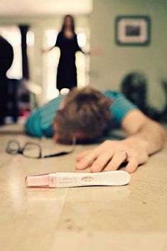 a person laying on the floor with their head down next to an electric toothbrush