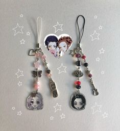 three different key chains with charms attached to them on a white surface, one has an image of a woman and the other has a heart