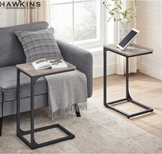 a living room with a gray couch, table and chair in front of a window