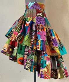 "A beautiful asymmetric cut skirt made in my multi color handmade patchwork. This patchwork is hand crafted from a variety of amazing African Wax textiles so each skirt will be unique from the one made before it but will be equally as colorful and vibrant. this could also be made in a variety of patchwork colors so let your imagination run wild and we can make a color scheme just for you. Pair it with a white T-shirt or crop top and chunky jewelry for that perfect mix of ease and comfort with Afrocentric Clothing, Handmade African