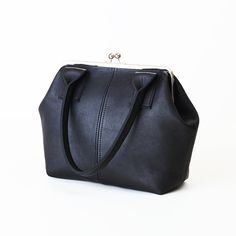 "This is a beautiful and roomy black leather kiss lock handbag. The leather used for this top handle frame bag is a very supple semi-structured leather (not rigid) and is available in FIVE colors (black, navy, dark brown, red or burgundy). You also have the choice of 8\", 9\" or 10\" shoulder strap drop. Would you like to see more kiss lock handbag design styles I carry in my shop? Here's a link to those handbags: https://etsy.me/32RZuJ0 D E T A I L S : * 100% cow hide leather. * Dimensions: Wid Kisslock Leather Handbags, Women Hand Bags, Handbag Design, Lady Dior Handbag, Expensive Bag, Luxury Bags Collection, Frame Purse, Girly Bags, Cute Handbags